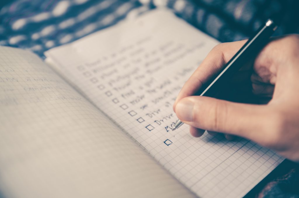 person creating checklists for retreat planning